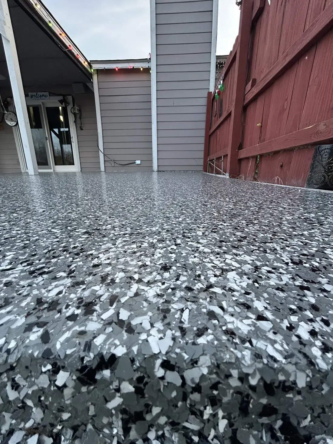 Close view of a black, white, and grey flake epoxy floor