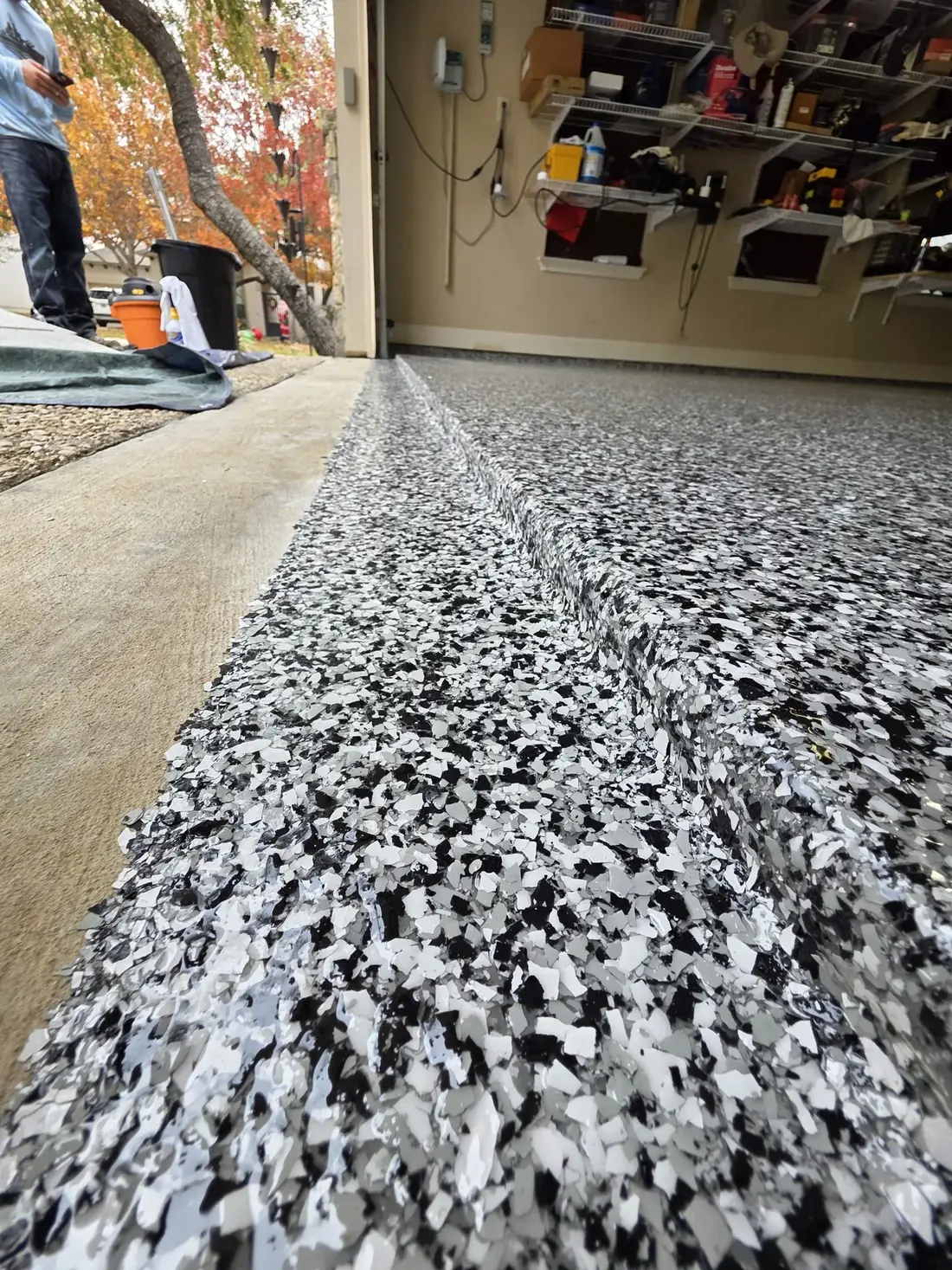 Residential garage with overhead storage and a new flake epoxy floor