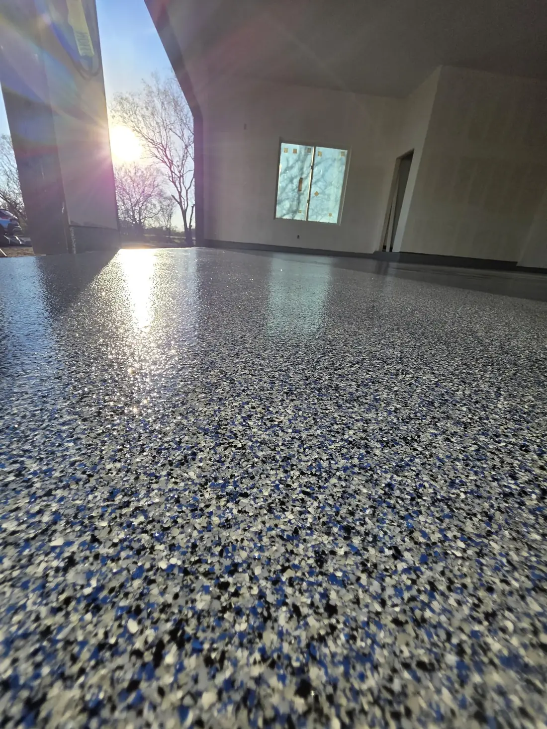 High-gloss garage floor coating reflecting the ceiling lights