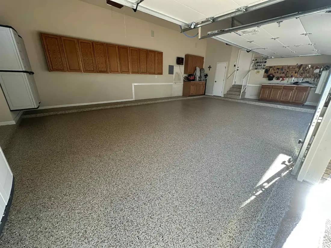 Finished three-car garage with a grey flake epoxy floor