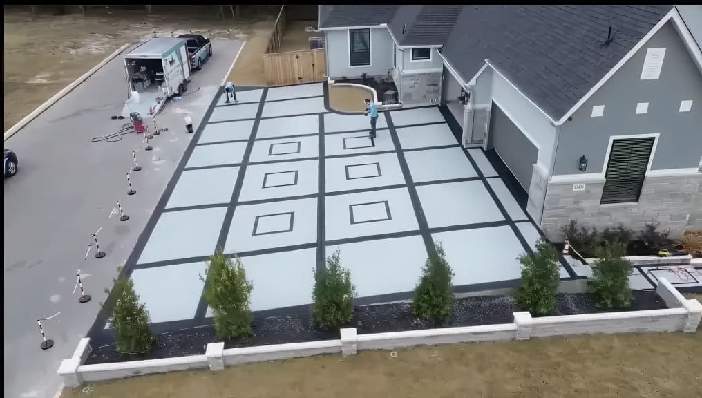 Aerial view of a San Antonio driveway coated in a decorative tile-pattern concrete finish