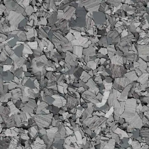 The image shows a close-up of gray, irregular stone chips or gravel, scattered uniformly, creating a textured and rough surface.