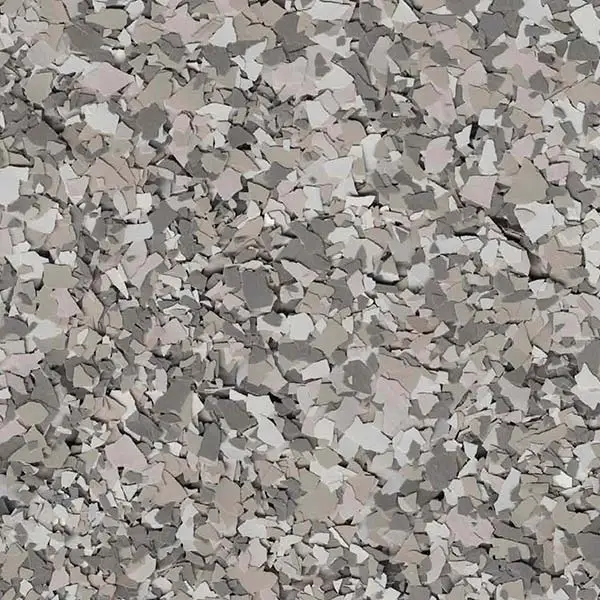 A close-up view of a textured surface with a random pattern of small, multicolored particles in shades of gray and beige.