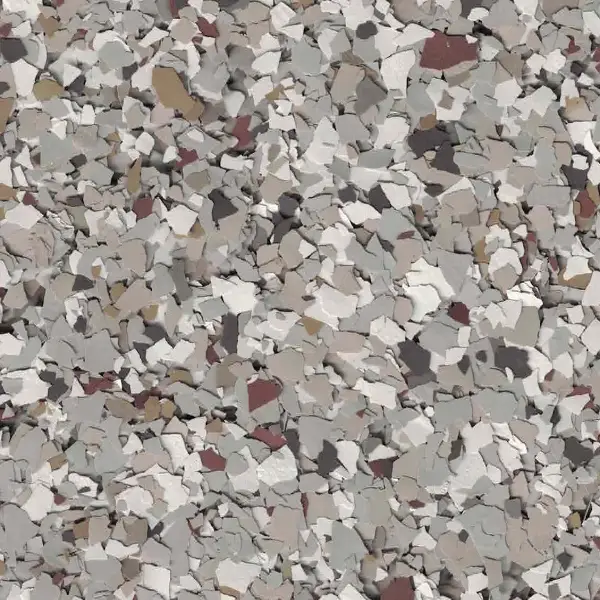 A close-up of a textured surface with variously colored stone or flake-like patterns in shades of grey, white, and brown.