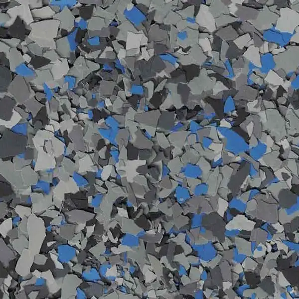 A close-up of a floor with scattered gray and blue chips, creating a textured and abstract pattern. No landmarks or people visible.